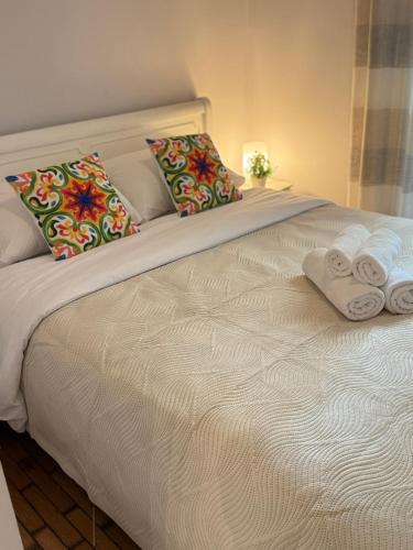 a bed with two towels and two pillows on it at Seaside Escape in Athens