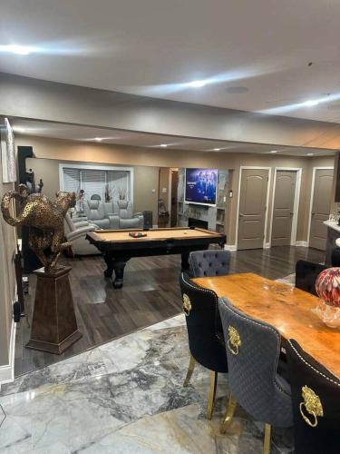 a living room with a pool table and a couch at The Marlowe, A Couples Getaway in Chicago