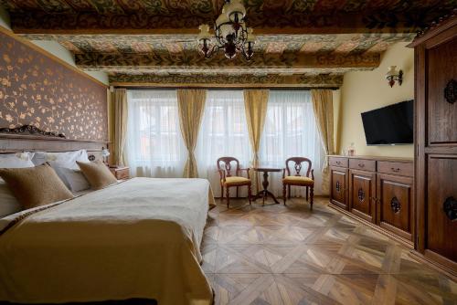 En eller flere senge i et værelse på Hotel Residence U Černého Orla