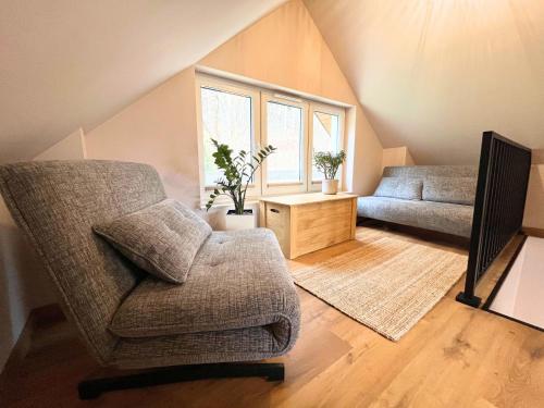 a living room with a chair and a couch at Domek przy czerwonym szlaku - The Red Trail Cabin in Węgierska Górka