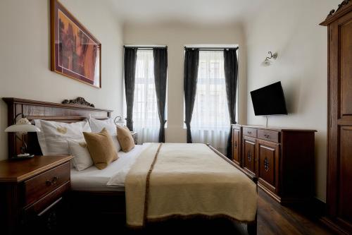 En eller flere senge i et værelse på Hotel Residence U Černého Orla