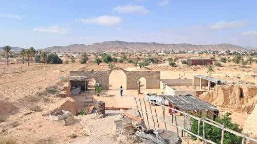 a building in the middle of a desert at Dar massouada in Gabès