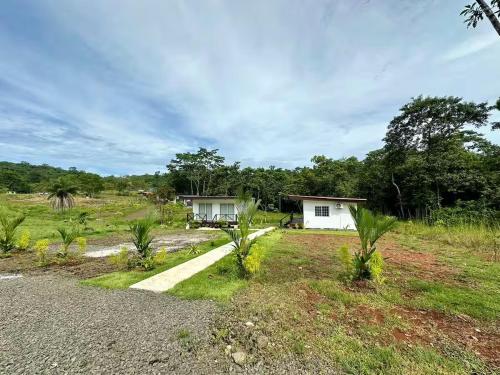 a small white house in the middle of a field at Villa Rio Grande in Santa Catalina