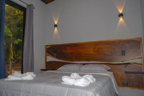 Un dormitorio con una cama con toallas. en Villa Centinela, en Monteverde