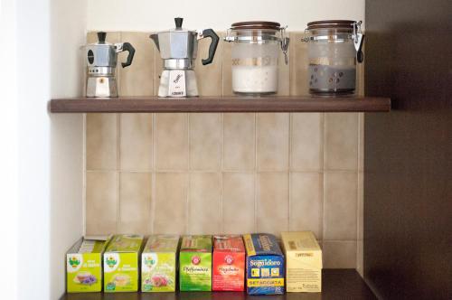 a shelf with milk and other food items on it at Rosso Tirano in Tirano