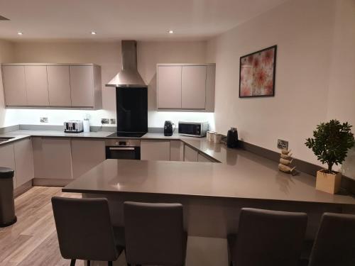 a large kitchen with a table and chairs in it at City Centre-Contactors-Professionals-Luxury Apartment in Nottingham