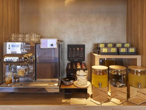 a kitchen with a coffee maker and a coffee machine at Swissotel Nankai Osaka in Osaka