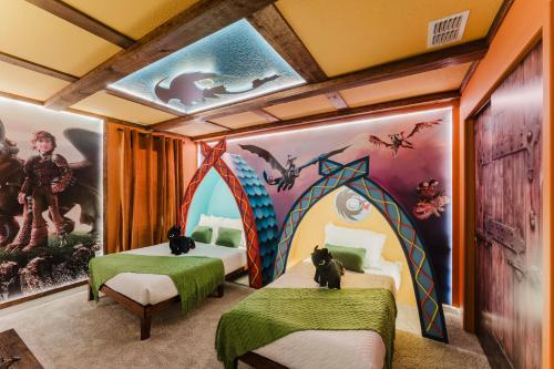 two beds in a room with a mural at Spacious 9BR Home w Private PoolGame Room in Davenport