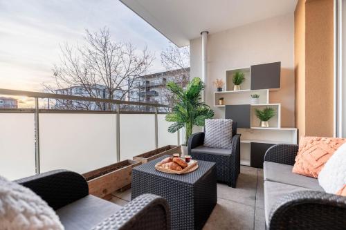 a living room with furniture and a large window at Le Magnifique - Grand balcon - Netflix - Grand Marché in Saint-Priest