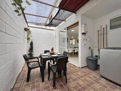 a dining room with a black table and chairs at Casa campestre Curiti in Curití