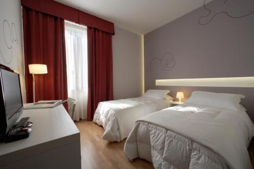 Una cama o camas en una habitación de Hotel Forte del 48