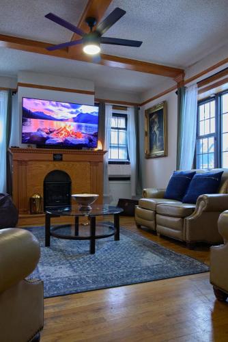 a living room with a large flat screen tv at Sweet Home - Zoller Stays in Long Island City