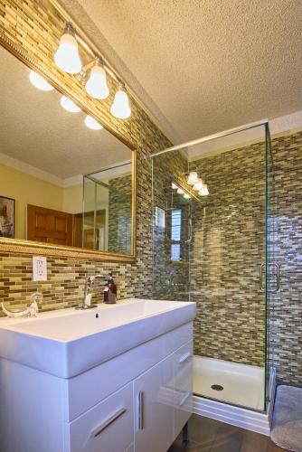 a bathroom with a white sink and a shower at Sweet Home - Zoller Stays in Long Island City