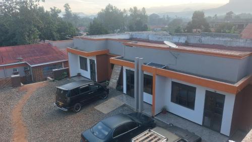 a black truck parked outside of a house at Palm Suites Unit3 in Mbale