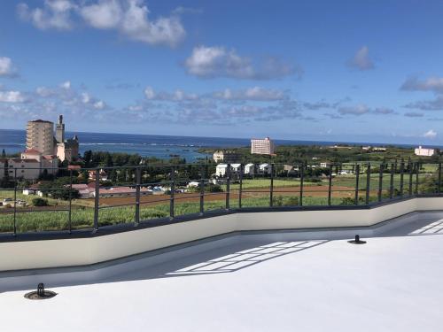 a balcony with a view of the ocean at Villa resort -悠- in Miyakojima