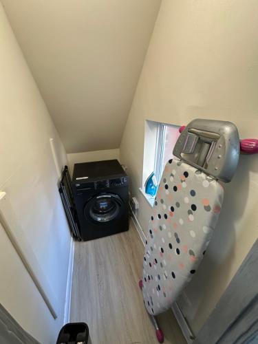 a bed in a small room with a refrigerator at City Centre 3 Bedrooms House with 2 Free Parking in Nottingham