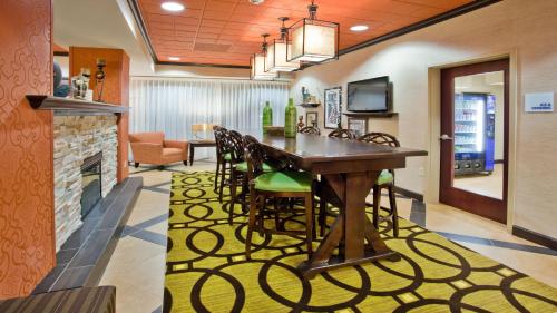 a dining room and living room with a table and chairs at Holiday Inn Express Peachtree Corners-Norcross by IHG in Norcross