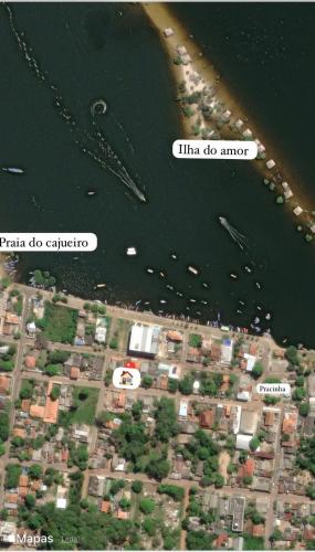 two descriptions of a city and a river with boats at Casa Orquídea Alter do Chão in Alter do Chao