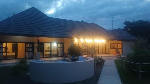 a house with lights on the front of it at Fikani game lodge in Thabazimbi