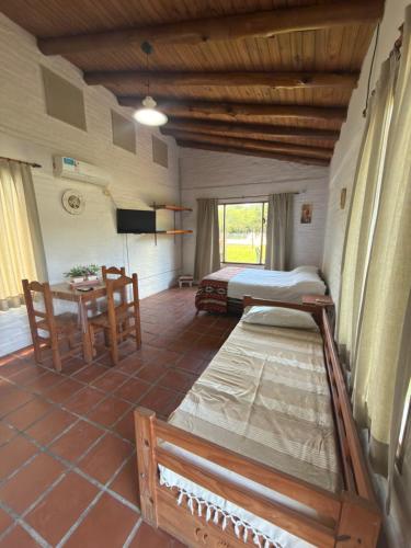 a bedroom with a bed and a table in a room at Cabañas Las Victorias in Colón