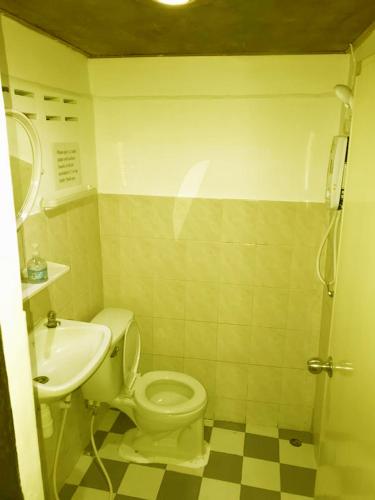 a bathroom with a toilet and a sink at Share Safari Cottage in Udawalawe