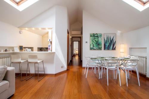 a dining room with a table and chairs at Il camino felice - 201 by Houset in Monza
