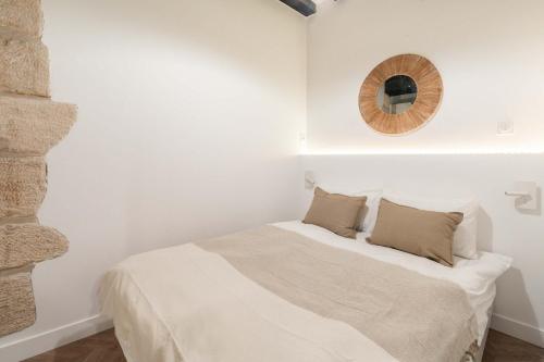 a bedroom with a bed with a mirror on the wall at Charmante Suite - LSP le Marais in Paris