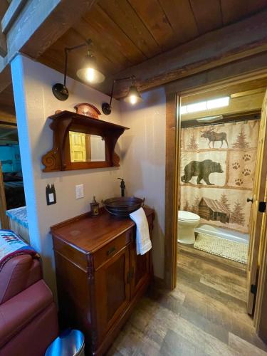 a bathroom with a sink and a toilet in a room at Riverfront, Authentic, Luxury Log Cabin-Bull Moose in Wasilla