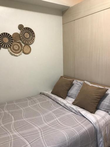 a bedroom with a bed with two pillows at Apartment in Rizal short stay only in Teresa