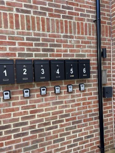 a brick wall with black and white signs on it at Central 2BR Home with Parking near Ferry in Dover
