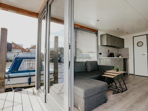 a living room with a couch and a table at Harbour Lodge at Uitgeestermeer View in Uitgeest