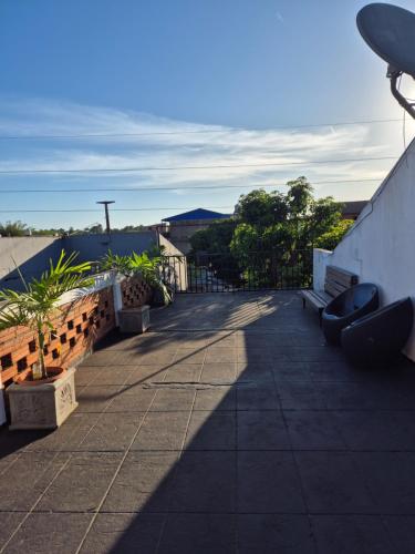 a patio with benches on the side of a building at Dpto Céntrico con Balcón Dpto 1 in Puerto Iguazú