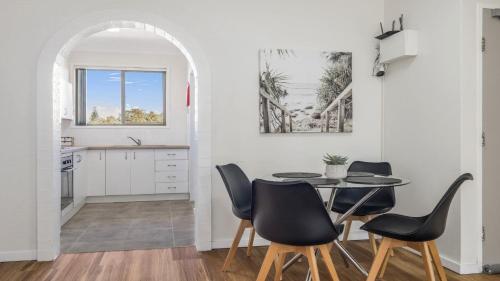 a dining room with a table and chairs at Flynns Beach Seascape in Port Macquarie