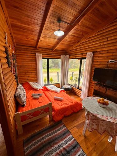 a bedroom with a large bed in a log cabin at Cabañas en Concordia in Concordia