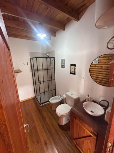 a bathroom with two toilets and a sink at Cabañas en Concordia in Concordia