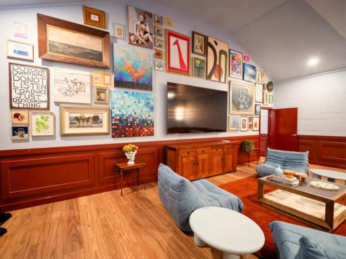 a living room with a large wall of art at The Sienna Hunter Valley in Luskintyre