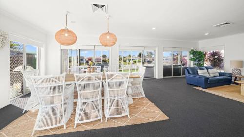 a kitchen and living room with a table and chairs at Hibbard Waterfront Escape in Port Macquarie