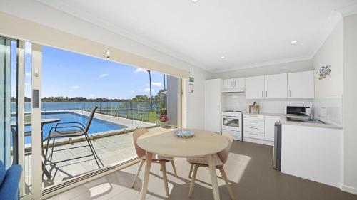 a kitchen and dining room with a table and chairs at Studio Living in Port Macquarie