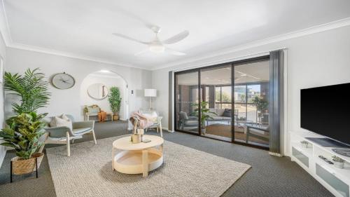 a living room with a flat screen tv and a couch at 9 Matthew Flinders Drive in Port Macquarie