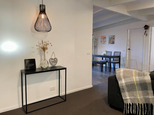 a living room with a couch and a table at Peaceful 3BR Family Home with free Parking and Garden Oasis in Bayswater