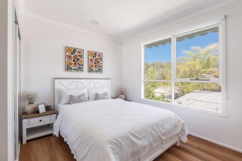 En eller flere senge i et værelse på Foreshore Haven - Poolside Comfort near Rye Beach