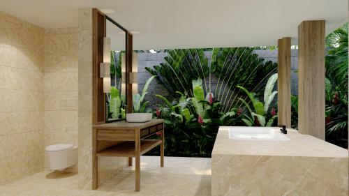 a bathroom with a sink and a mirror at The One Boutique Villa in Seminyak