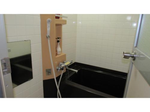 a bathroom with a bath tub in a bathroom stall at Utsunomiya Inter Resort Hotel - Vacation STAY 68891v in Utsunomiya