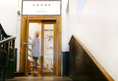 a person standing in front of a door at Abode Bombay in Mumbai
