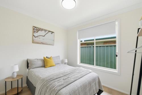 a bedroom with a bed and a window at Bellbird Willow Hunter Escape by Nature & Winery in Bellbird