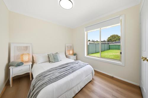 a bedroom with a bed and a window at Bellbird Willow Hunter Escape by Nature & Winery in Bellbird