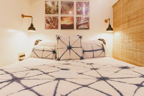 a bedroom with a bed with a blue and white comforter at Abode Bombay in Mumbai