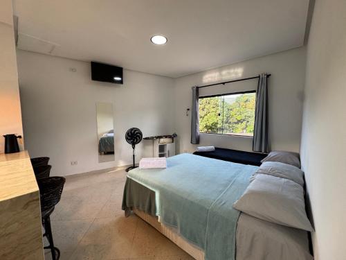 パウメイラスにあるFlat Completoの大きなベッドと窓のある寝室