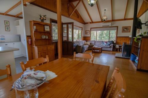 a kitchen and living room with a wooden table at Settlers Chalet in Kalgan