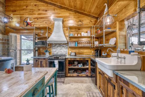 a kitchen with a sink and a stove at Frio Hills Hideaway in Leakey